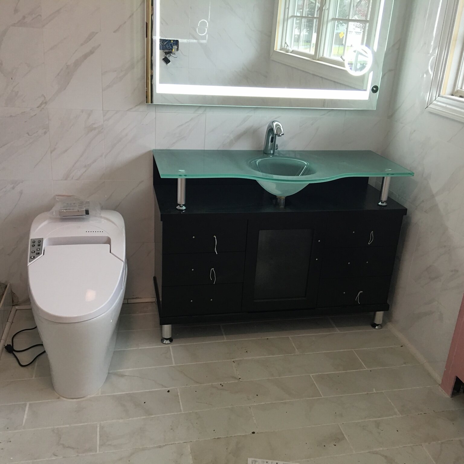 Modern bathroom vanity, sink and toilet installation